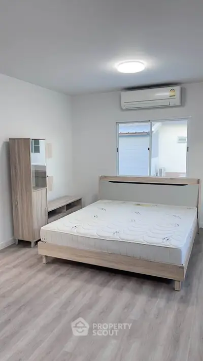 Modern minimalist bedroom with wooden furniture and natural light