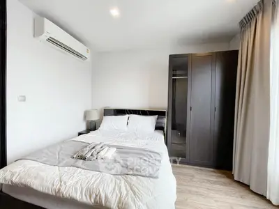 Modern bedroom with air conditioning and wardrobe in stylish apartment