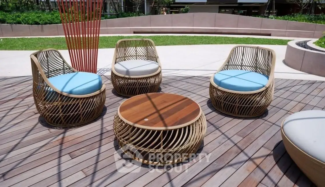 Stylish outdoor seating area with modern wicker furniture on a wooden deck, perfect for relaxation.