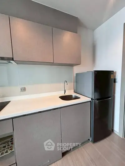 Modern kitchen with sleek cabinets and stainless steel fridge