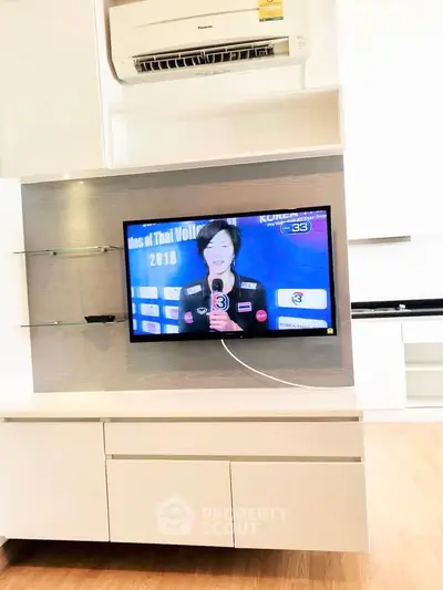 Modern living room with wall-mounted TV and sleek air conditioning unit.