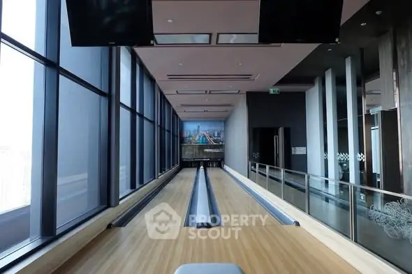 Luxurious high-rise building with indoor bowling alley and panoramic city views.
