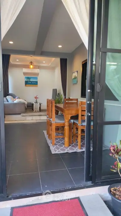 Charming open-layout living and dining area with modern decor and cozy ambiance.