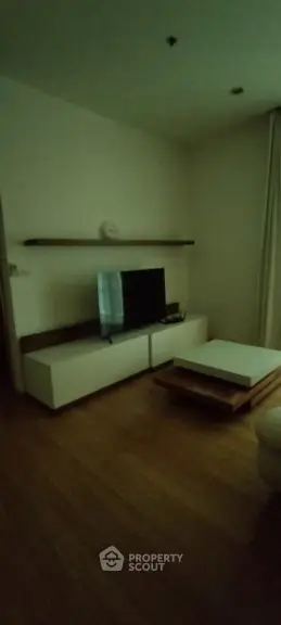 Cozy living room with modern TV stand and wooden flooring