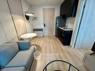 Modern compact living room with kitchenette and stylish decor