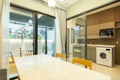 Modern kitchen with washing machine and open layout dining area