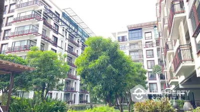 Modern apartment building with lush garden and spacious balconies