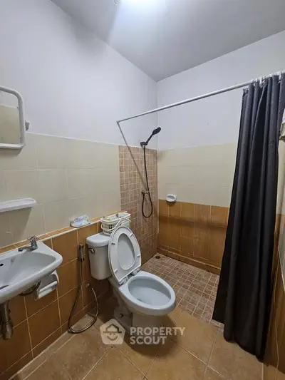 Spacious bathroom with modern fixtures and walk-in shower in a contemporary home.