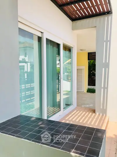 Modern exterior with sliding glass doors and stylish overhang