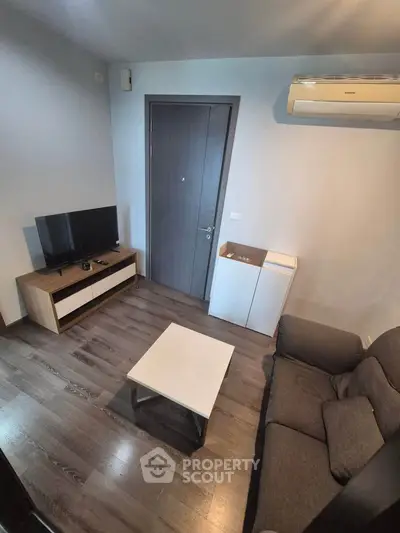 Modern living room with sleek furniture and air conditioning, perfect for cozy relaxation.