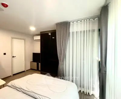 Modern bedroom with sleek design, featuring a large window with curtains and a stylish wardrobe.