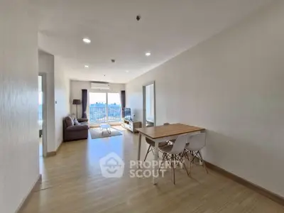 Spacious modern living room with dining area and city view balcony