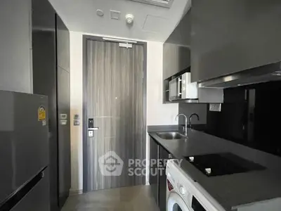 Modern compact kitchen with sleek appliances and stylish cabinetry in urban apartment.