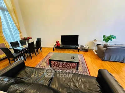 Spacious living room with elegant decor and large windows for natural light.