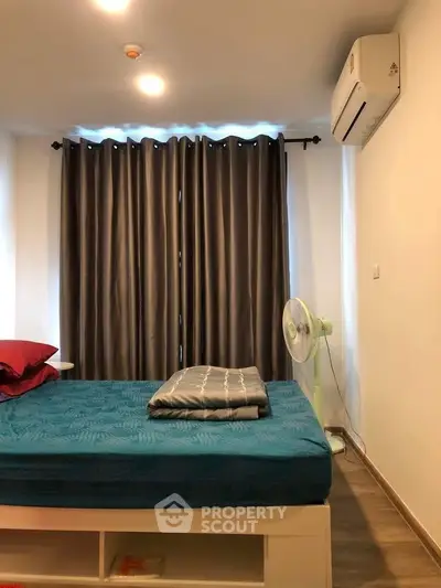 Cozy bedroom with modern decor, featuring a comfortable bed, air conditioning, and elegant curtains.