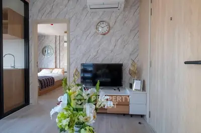 Modern living room with stylish decor and open view to bedroom