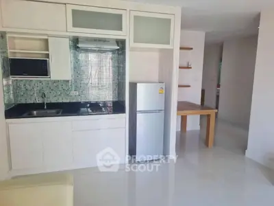 Modern kitchen with sleek appliances and open layout in a bright apartment