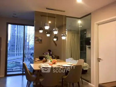 Modern dining area with elegant lighting and city view balcony