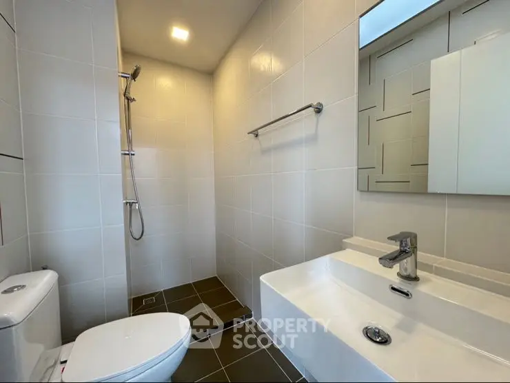 Modern bathroom with sleek fixtures and walk-in shower design.