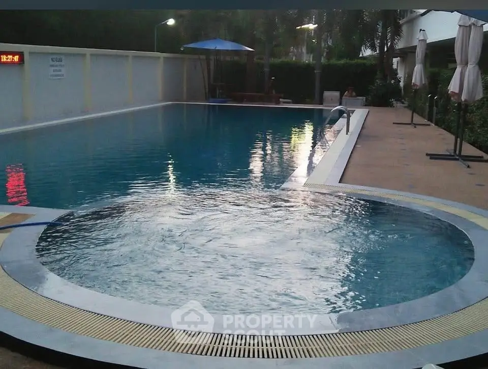 Luxurious swimming pool with jacuzzi in a serene residential setting