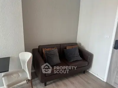 Cozy living room with brown sofa and modern decor, perfect for relaxing.