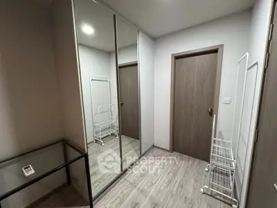 Modern storage room with mirrored wardrobe and sleek flooring