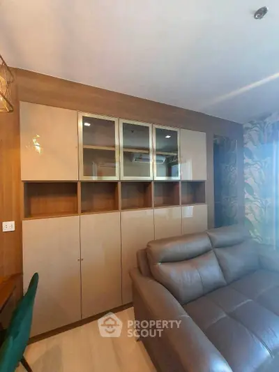 Modern living room with sleek cabinetry and comfortable leather sofa