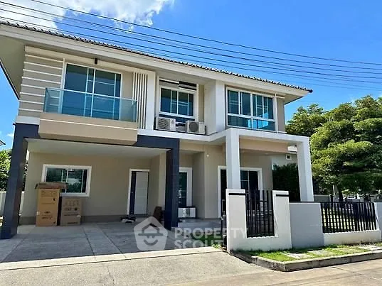 Modern two-story house with spacious driveway and balcony, perfect for family living.