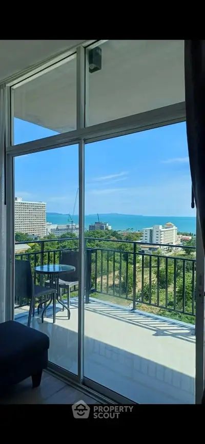 Stunning balcony view with ocean and cityscape, perfect for relaxation and enjoying the scenery.