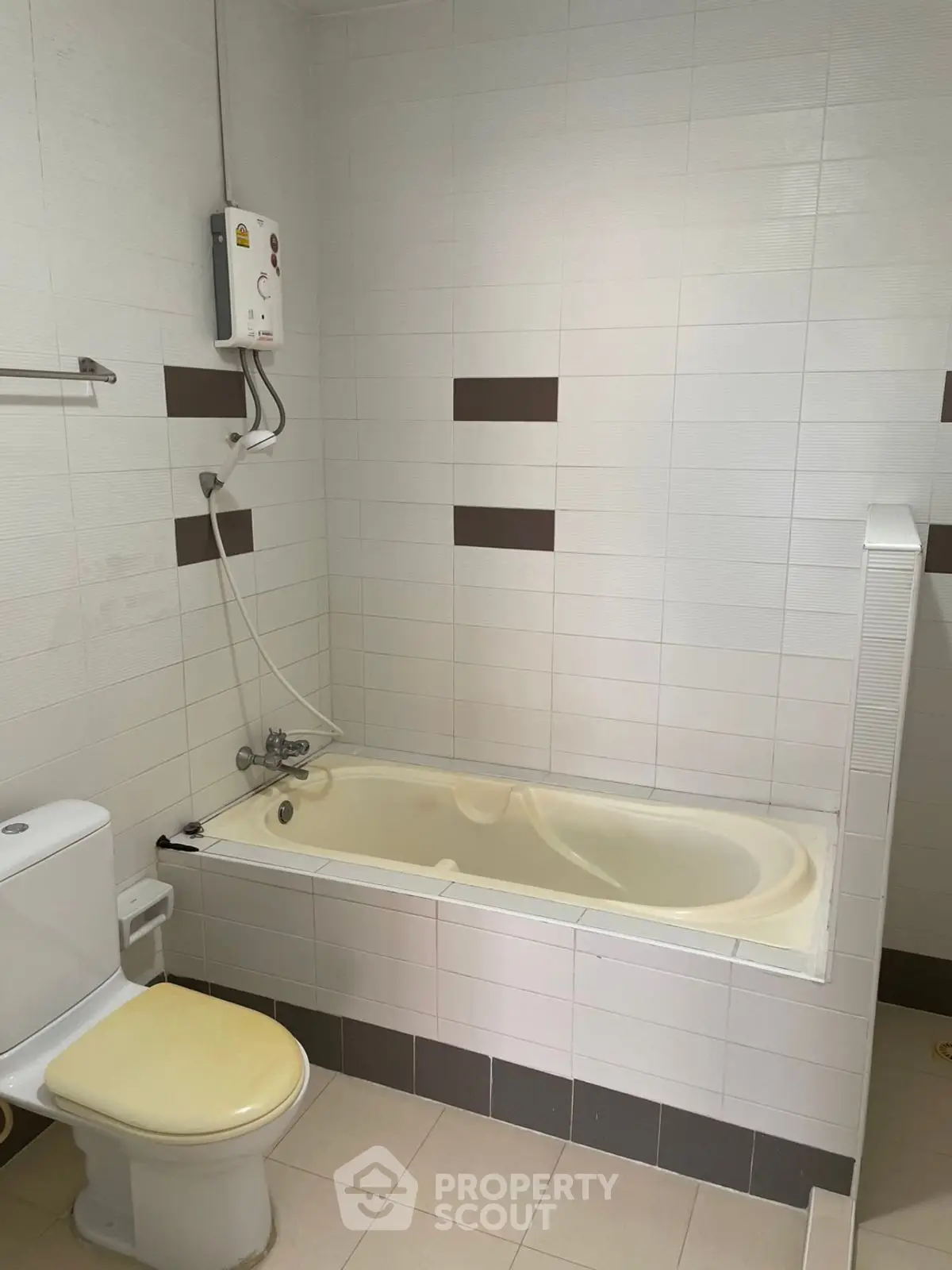 Modern bathroom with bathtub and shower in sleek white tile design.