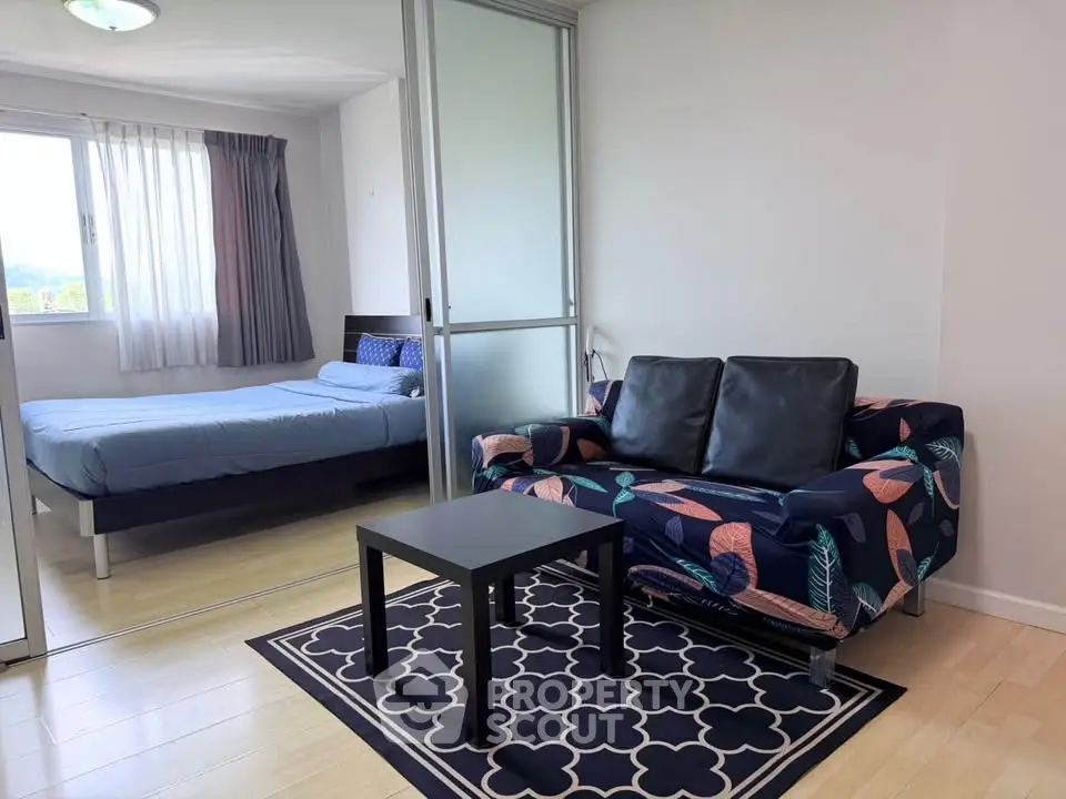 Modern apartment with cozy living room and bedroom, featuring stylish decor and natural light.