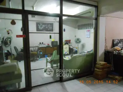 Cozy living room with glass doors and eclectic decor, perfect for relaxation.