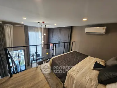 Modern loft bedroom with stylish decor and large windows offering natural light
