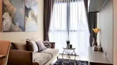 Elegant living room with modern decor and large window for natural light.