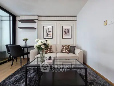 Modern living room with elegant decor, featuring a cozy sofa, stylish coffee table, and chic wall art.