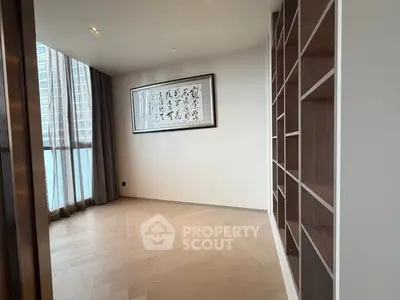Spacious modern study with built-in shelves and large window view.
