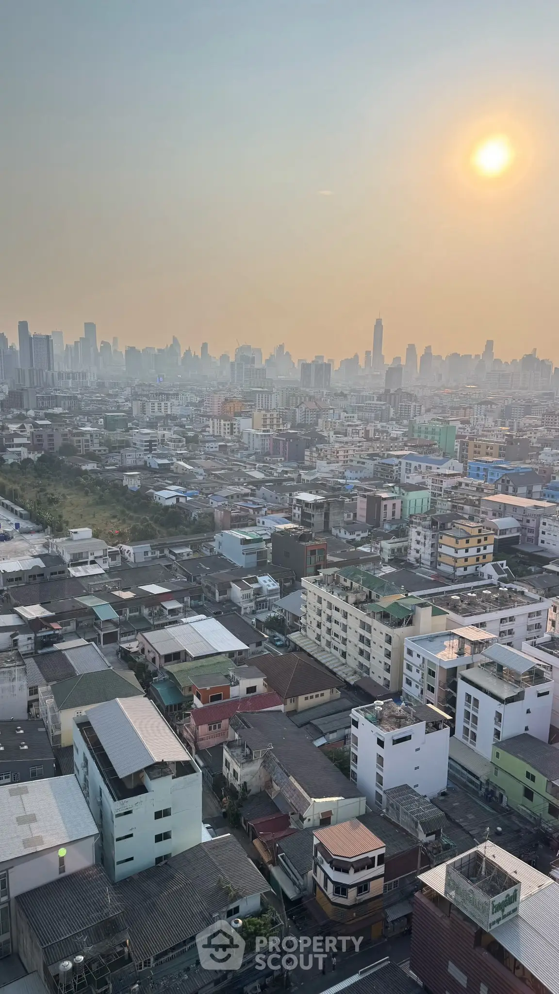 Stunning cityscape view from high-rise building at sunset, showcasing urban skyline and vibrant city life.
