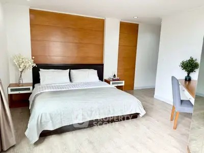 Spacious modern bedroom with elegant wooden accents and cozy decor