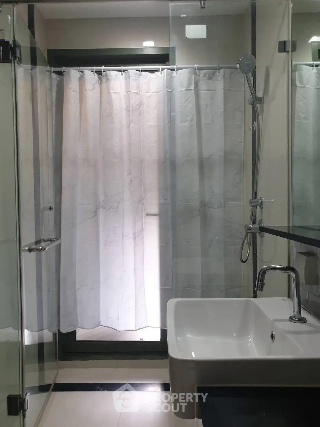 Modern bathroom with glass shower and sleek sink design