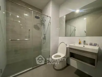 Modern bathroom with glass shower and sleek fixtures