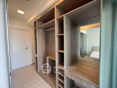 Spacious walk-in closet with modern wooden shelving and ample storage space.