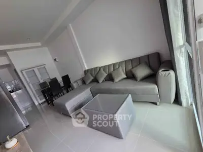 Modern living room with sleek gray furniture and natural light