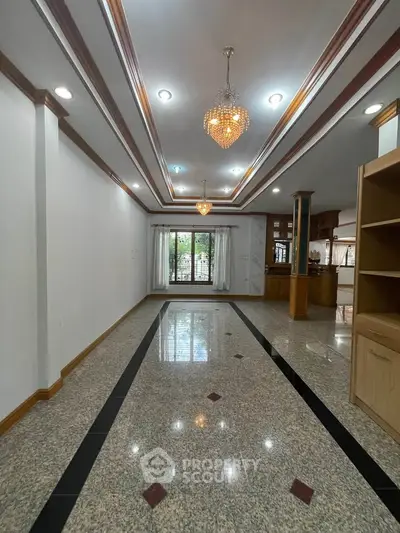 Spacious living room with elegant lighting and polished flooring, perfect for modern living.