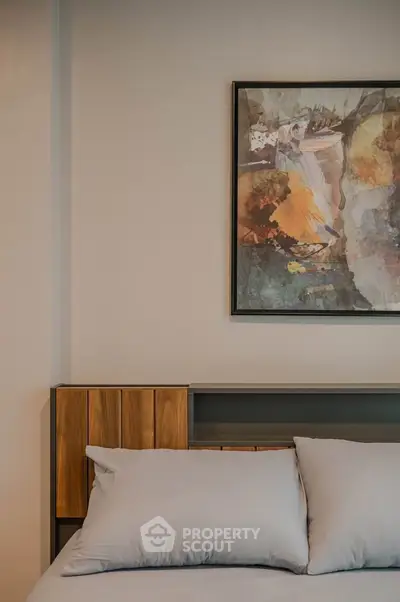 Modern bedroom with stylish artwork and cozy bedding