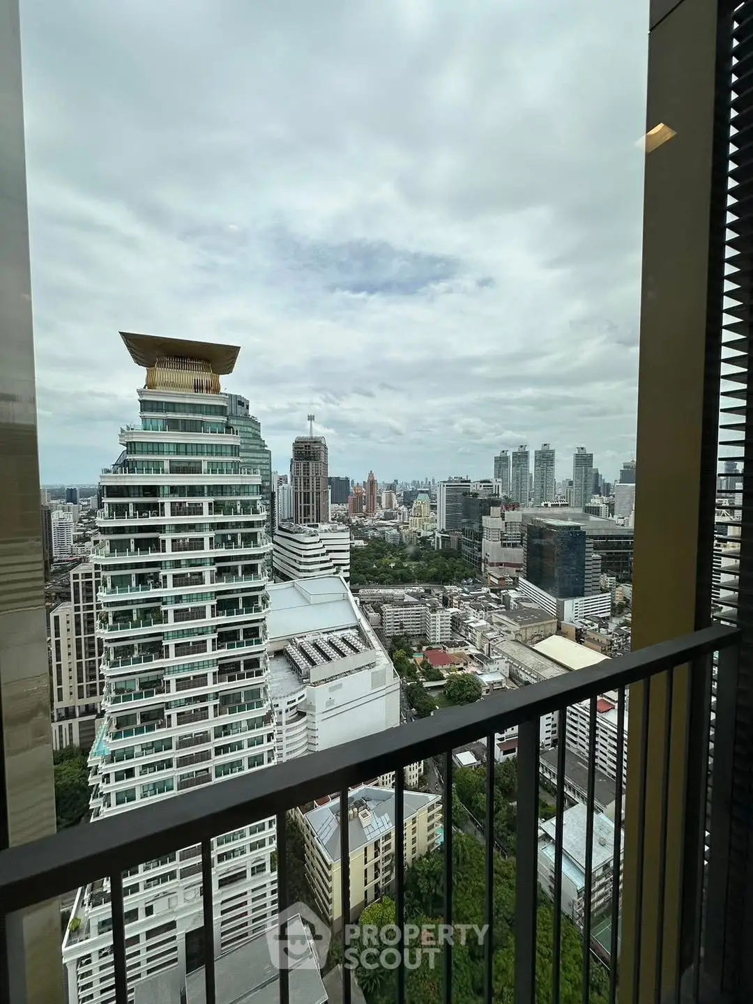 Stunning cityscape view from high-rise balcony with modern architecture.