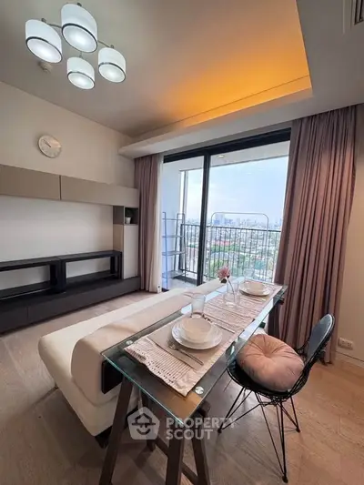Modern living room with dining area and balcony view in a stylish apartment.