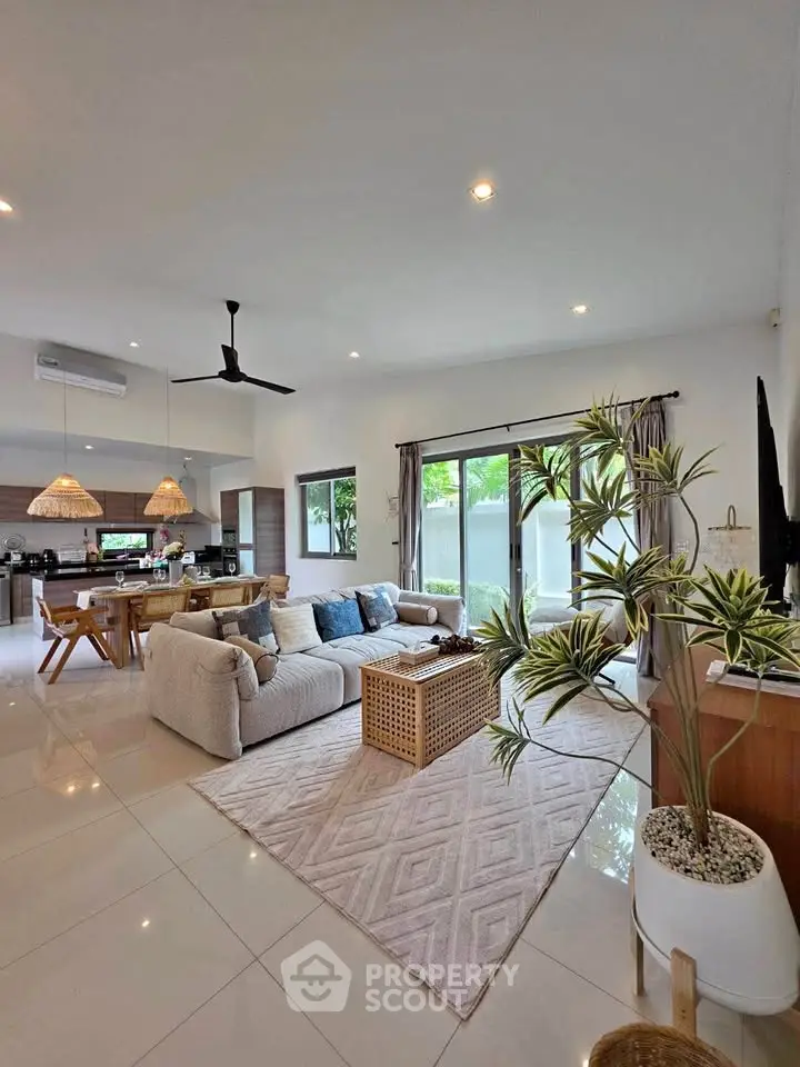 Spacious modern living room with open kitchen and stylish decor