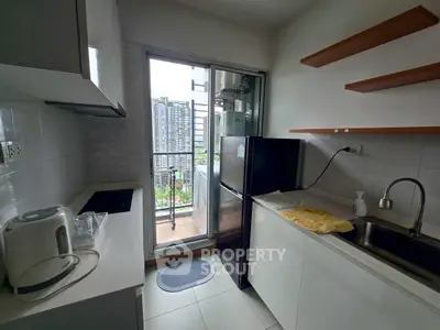 Modern kitchen with balcony view, sleek appliances, and open shelving in urban apartment.