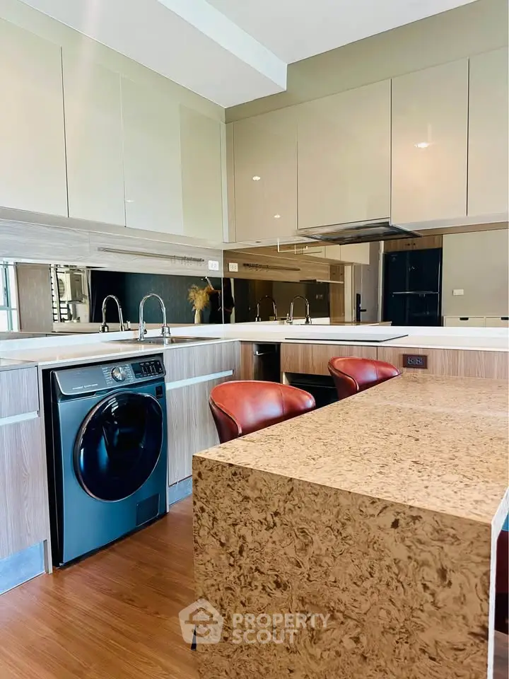 Modern kitchen with sleek appliances and stylish island seating