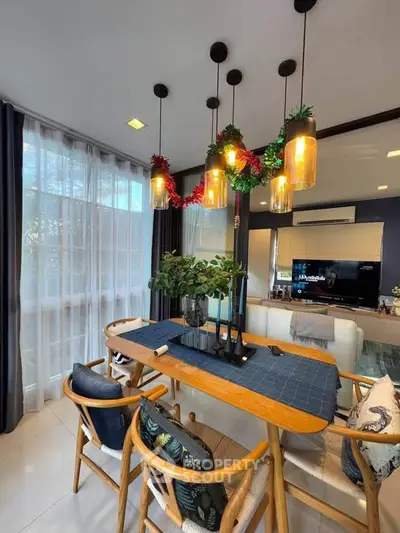 Stylish dining area with modern lighting and elegant decor in a cozy home setting.
